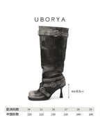 UBORYA Black Slouchy Knee-High Boots with Buckle Straps and Sculptural Heel