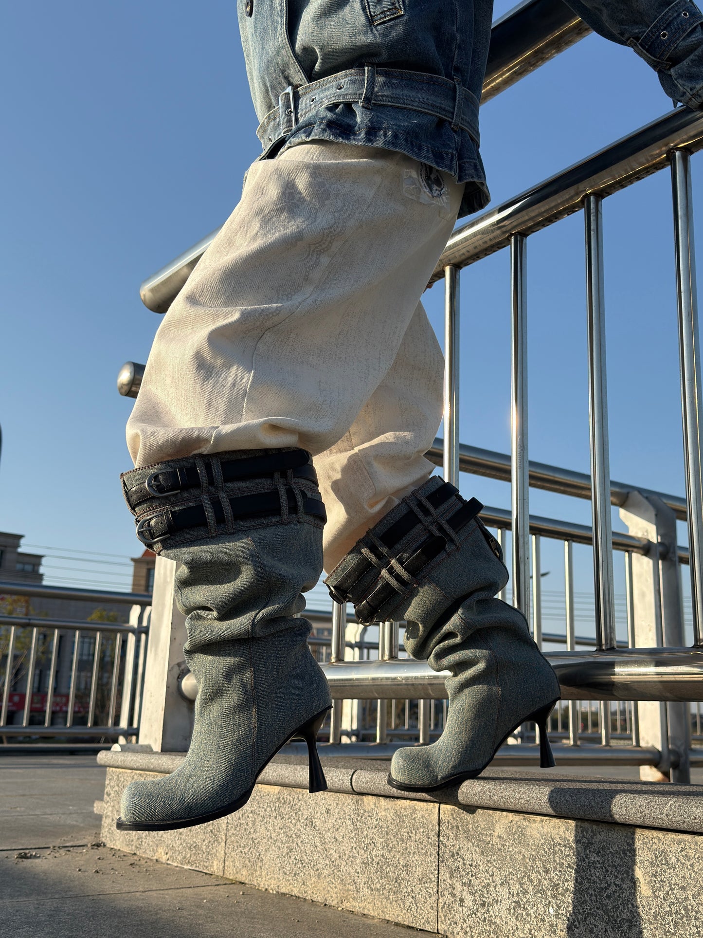 UBORYA Denim Slouchy Knee-High Boots with Black Buckle Straps – Sculptural Kitten Heel Boots for Women | Distressed Jean Booties | Avant-Garde Denim Punk Footwear